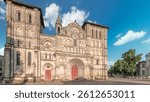 Eglise Abbatiale Sainte-Croix timelapse hyperlapse in Bordeaux, France, Romanesque Catholic church with a medieval facade. Landmark showcases rich architectural and cultural heritage under a blue sky