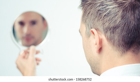 ego man reflection in mirror on a white background