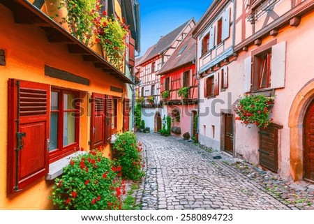 Eguisheim, France. Charming Alsace village, features colorful half-timbered houses, cobblestone streets, vineyards and medieval charm.