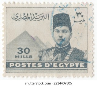 EGYPT - 1939: An 30 Milliemes Grey Postage Stamp Showing Portrait Of King Farouk And Pyramids. Tenth Ruler Of Egypt From The Muhammad Ali Dynasty And The Penultimate King Of Egypt And The Sudan