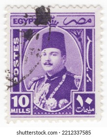 EGYPT - 1944: An 10 Milliemes Deep Violet Postage Stamp Showing Portrait Of King Farouk I. Tenth Ruler Of Egypt From The Muhammad Ali Dynasty And The Penultimate King Of Egypt And The Sudan