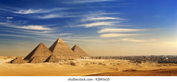 Egypt. Cairo - Giza. General view of pyramids and cityskape from the Giza Plateau (on front side: three pyramids known as Queens' Pyramids; next: the Pyramid of Menkaure, Khafre and Chufu)