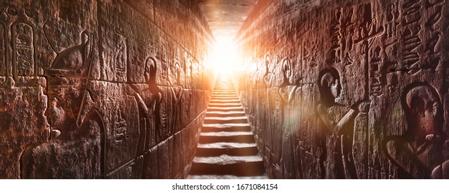 Egypt Edfu temple, Aswan. Passage flanked by two glowing walls full of Egyptian hieroglyphs, illuminated by a warm orange backlight from a door - Shutterstock ID 1671084154