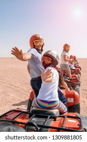 Egypt / Hurghada - 01/05/2016: A Group Of Happy People Ride Quad Bikes In The Desert.