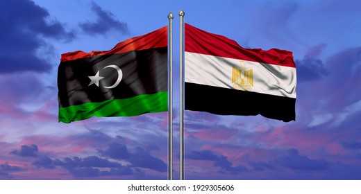 Egypt And Libya Flag Waving In The Wind Against White Cloudy Blue Sky Together. Diplomacy Concept, International Relations.

