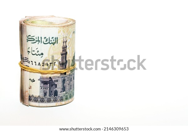 Egypt money roll pounds isolated on white\
background, 200 LE two hundred Egyptian pounds cash money bills\
rolled up with rubber bands with a image of Qani Bay mosque on the\
banknote, selective focus