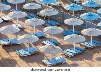 Egypt. Sharm el-Sheikh. Beach umbrellas from the sun and sun loungers on the beach.
