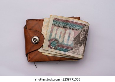 Egyptian 100 pound banknote on a wallet isolated on a white background
 - Shutterstock ID 2239791333