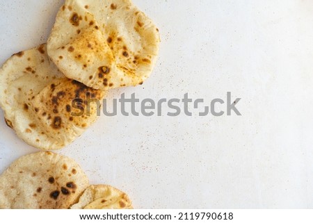 Egyptian Arab flatbreads - Aish Baladi top view on a beige background with copy space 