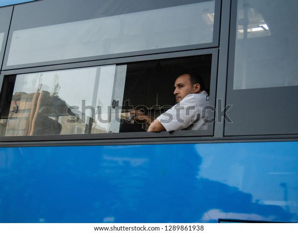 An Egyptian employee looking out of\
a public transport bus, Cairo, Egypt, July 27,\
2014