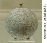 Egyptian faience flask with lotus decoration from Poti, dated to the 7th century BCE, spherical vessel used for ritual or cosmetic liquids.