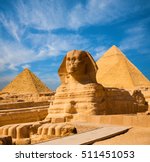Egyptian Great Sphinx full body portrait with head, feet with all pyramids of Menkaure, Khafre, Khufu  in background on a clear, blue sky day in Giza, Egypt empty with nobody. copy space