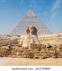 Egyptian Great Sphinx Full Body Portrait With Head, Feet With All Pyramids Of Menkaure, Khafre, Khufu In Background On A Clear, Blue Sky Day In Giza, Egypt Empty With Nobody. Copy Space.