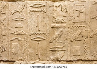 Egyptian Hieroglyphs Engraved On An Ancient Stone Wall 