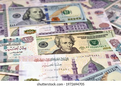 Egyptian money and American dollars banknotes background, various Egyptian pounds and American dollar bills, selective focus, 200 pounds, 100 pounds, 100 dollars bill and 20 dollars bill