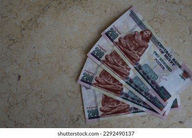 egyptian money. A fragment of reverse side of 200 Egyptian pounds banknote, observe side has an image of Mosque of Qani-Bay Cairo, Egypt. reverse side has an image of The Seated Scribe.  - Shutterstock ID 2292490137