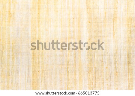 Egyptian papyrus paper texture background. Papyrus is used in ancient times as writing surface, made from the pith of papyrus plant named Cyperus papyrus, widely used across the Mediterranean region.