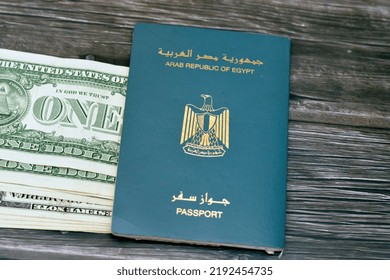 Egyptian Passport With American Dollars Of 1 $ One United States Money Banknotes Isolated On Wooden Background, Arab Republic Of Egypt's Passport With The Republican Golden Eagle And American Money