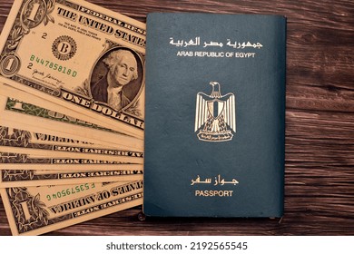 Egyptian Passport With American Dollars Of 1 $ One United States Money Banknotes Isolated On Wooden Background, Arab Republic Of Egypt's Passport With The Republican Golden Eagle And American Money