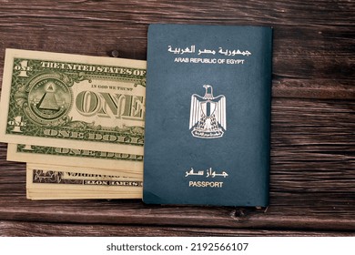 Egyptian Passport With American Dollars Of 1 $ One United States Money Banknotes Isolated On Wooden Background, Arab Republic Of Egypt's Passport With The Republican Golden Eagle And American Money