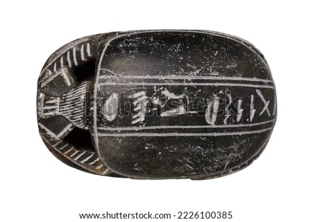 egyptian stone scarab with hieroglyphs isolated on white background