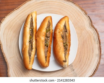 Egyptian Traditional Food, Liver And Green Pepper Sandwiches On White Plate And Wooden Log, Homemade