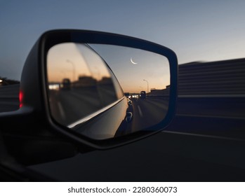 the eid moon looks on car looking glass