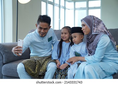 Eid Mubarak Celebration Moment, Malay Family Taking A Selfie Together At Home.