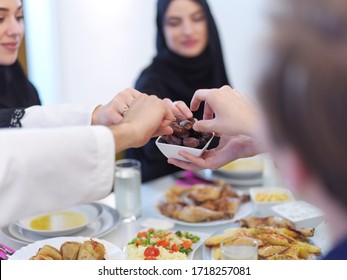 Eid Mubarak Muslim Family Having Iftar Dinner Eating Dates To Break Feast. Eating Traditional Food During Ramadan Feasting Month At Home. The Islamic Halal Eating And Drinking At Modern Western Islam