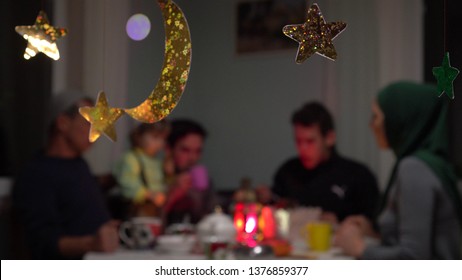 Eid Mubarak. Muslim people eating food during Iftar at home. Traditional evening meal for Ramadan. The Islamic Halal Eating and Drinking - Shutterstock ID 1376859377