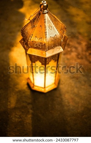 Eid Mubarak and Ramadan Kareem concept background, Golden lantern lamp on the nature with copy space for greeting text, glowing vintage lantern light