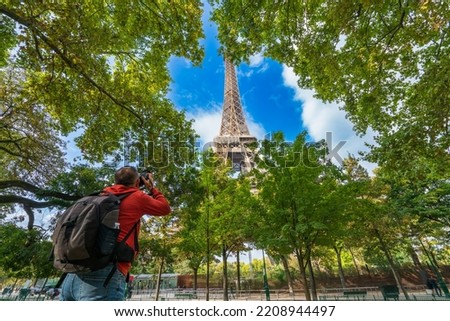 Eiffel Tower being captured by tourist photographer in Paris. France