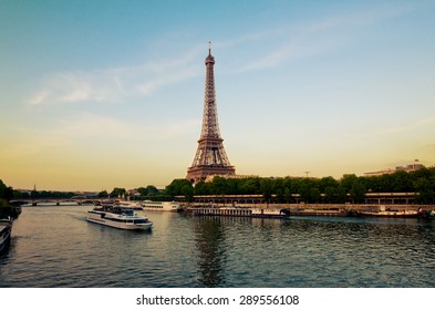 Eiffel Tower with boats in evening Paris, France