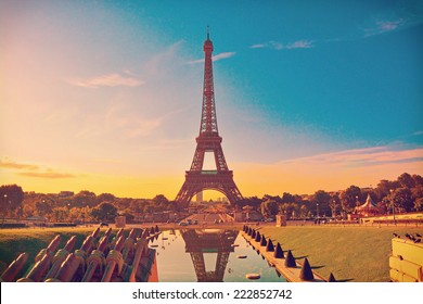 Eiffel Tower and fountain at Jardins du Trocadero at sunrise in Paris, France. Travel background with retro vintage instagram filter