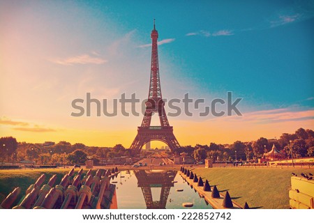 Eiffel Tower and fountain at Jardins du Trocadero at sunrise in Paris, France. Travel background with retro vintage instagram filter
