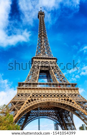 Similar – Eiffel Tower in green trees on blue sky