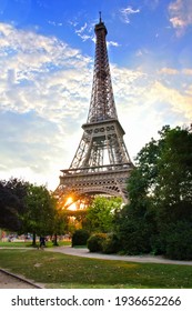 Eiffel Tower, iconic Paris landmark with setting sun and vibrant blue summer skies, France