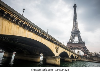 Eiffel Tower And Jena Bridge In A Cloudy Day