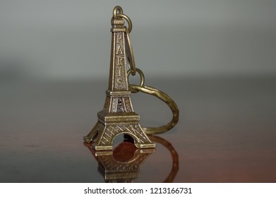 Eiffel Tower Keyring Keychain, Official Travel Souvenir And Symbol Of Paris - France, Isolated On Wood Background