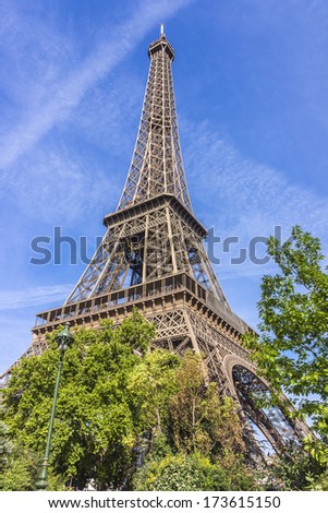 Similar – Eiffel Tower in green trees on blue sky