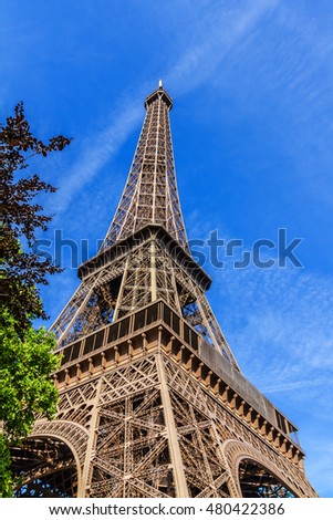 Similar – Eiffel Tower in green trees on blue sky