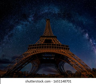 The Eiffel Tower At Night Under The Milky Way Galaxy In Paris, France. Low Angle Wide Perspective View