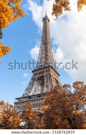 Similar – Eiffel Tower in green trees on blue sky