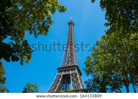 Similar – Eiffel Tower in green trees on blue sky