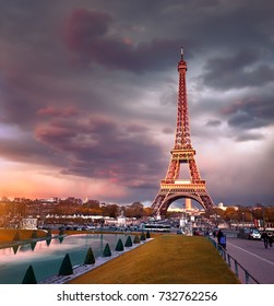 Eiffel tower on a sunset half-lit with last rays of the setting Sun. Panoramic toned image.