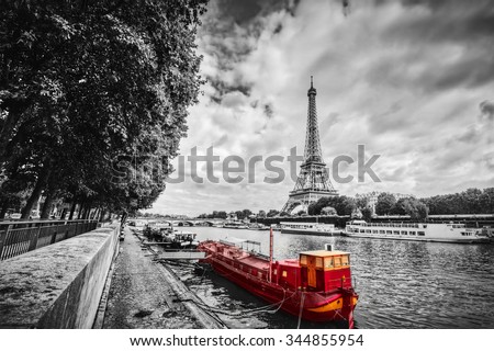 Eiffel Tower over Seine river in Paris, France. Red tourist ship on water. Vintage, black and white.