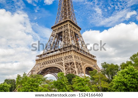 Similar – Eiffel Tower in green trees on blue sky