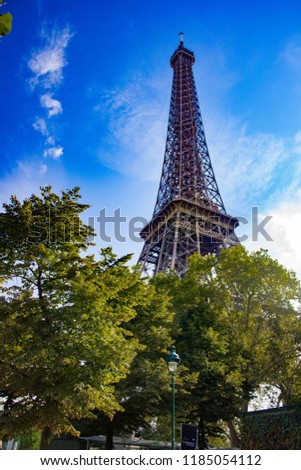 Similar – Eiffel Tower in green trees on blue sky