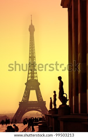 Eiffel Tower and silhouettes of sculptures. View from the Trocadero. Sanset.