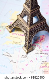 Eiffel Tower statue on a map of Paris